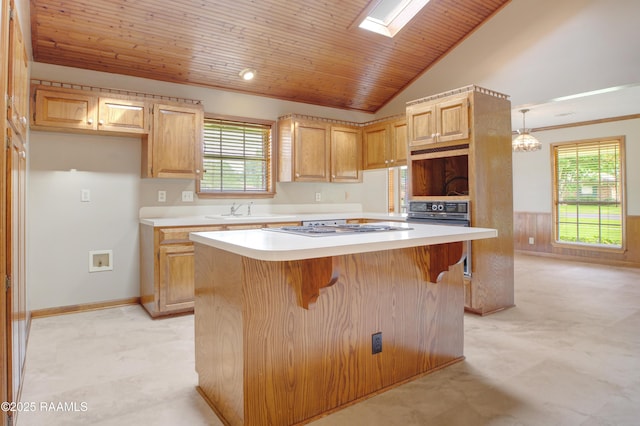 505 River Woods Dr, Lafayette, LA 70508 - kitchen with a sink, light countertops, lofted ceiling, a kitchen island, and a breakfast bar area
