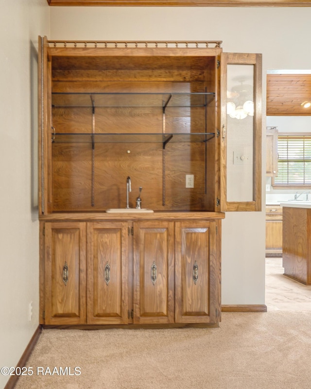 505 River Woods Dr, Lafayette, LA 70508 - bar featuring light carpet, a sink, and baseboards