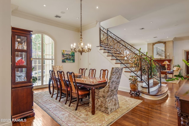 209 Princeton Woods Loop, Lafayette, LA 70508 - dining space featuring wood-type flooring, stairs, crown molding, recessed lighting, and a chandelier