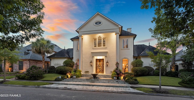 209 Princeton Woods Loop, Lafayette, LA 70508 - view of front facade with a chimney, a yard, and stucco siding