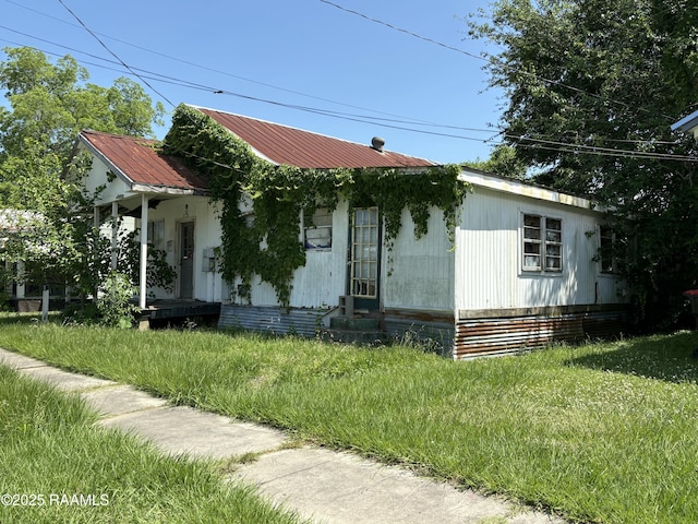 210 Hobson St, Lafayette, LA 70501 - view of front of house featuring a front lawn and metal roof