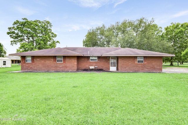 1341 College Rd, Eunice, LA 70535 - back of property featuring a lawn and brick siding