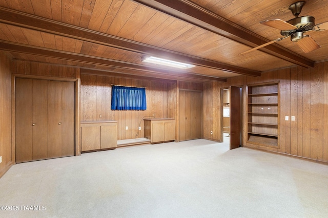 1341 College Rd, Eunice, LA 70535 - basement featuring wood ceiling, wood walls, carpet flooring, and a ceiling fan