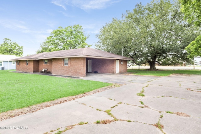 1341 College Rd, Eunice, LA 70535 - view of home's exterior with brick siding, a lawn, driveway, and a carport