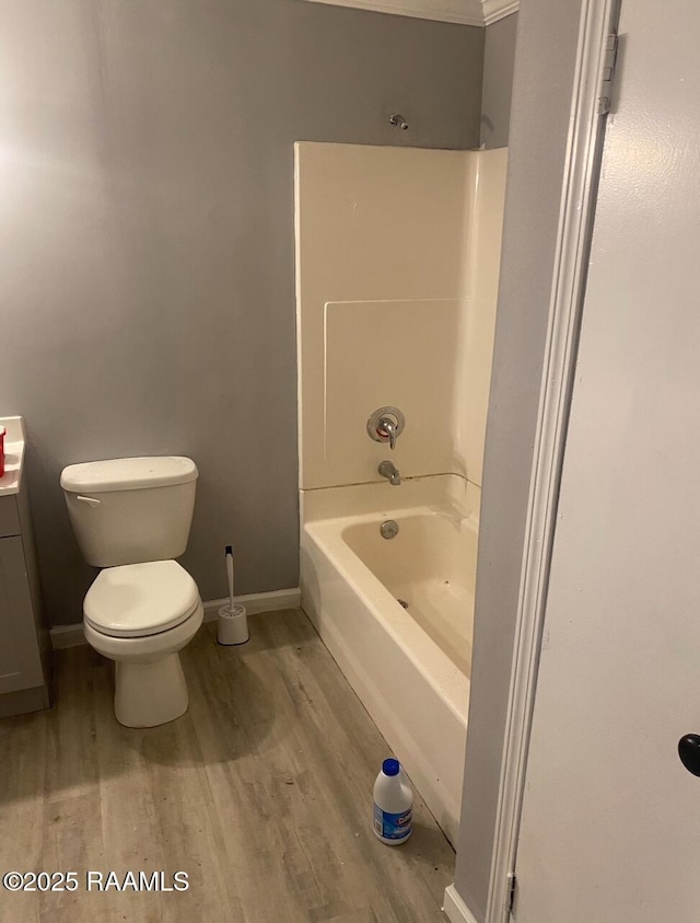 bathroom with wood finished floors, toilet, baseboards, and vanity