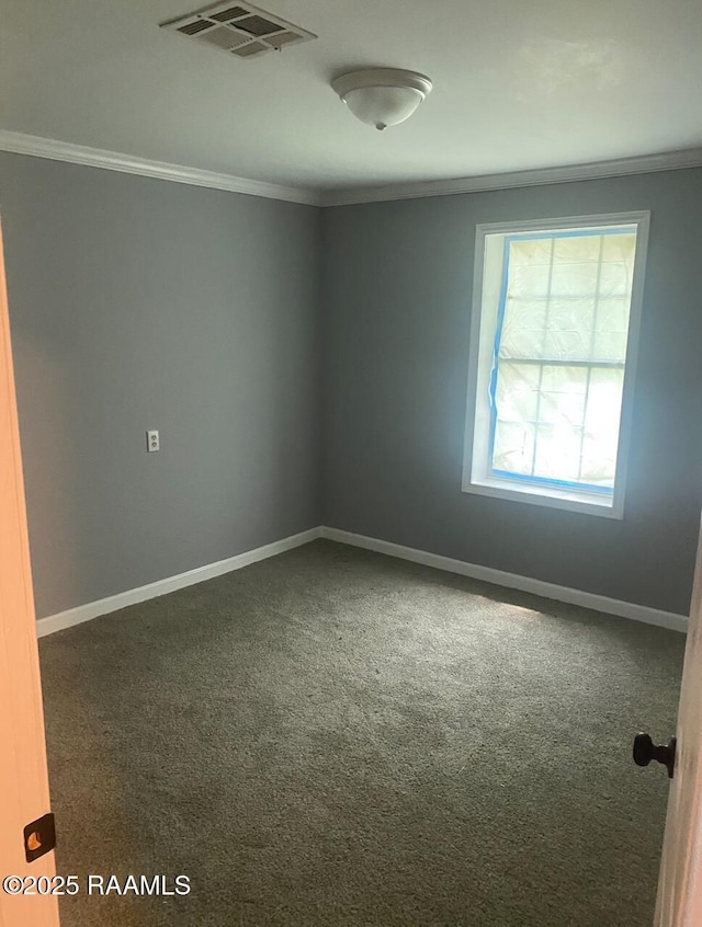 carpeted spare room featuring crown molding and baseboards