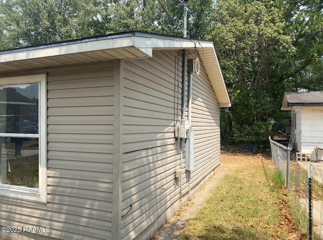 view of home's exterior featuring fence