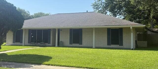 back of house with a yard and brick siding