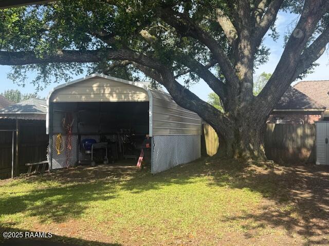 view of outbuilding featuring a carport and an outbuilding