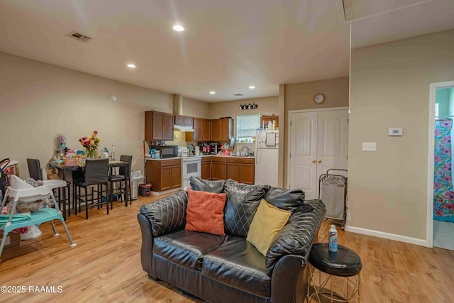255 Chatrian St, Grand Coteau, LA 70541 - living area featuring attic access, light wood finished floors, recessed lighting, and baseboards