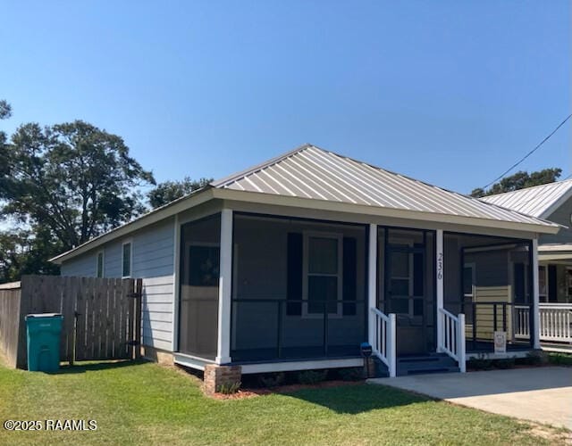 236 Chatrian St, Grand Coteau, LA 70541 - view of front facade featuring a sunroom and metal roof