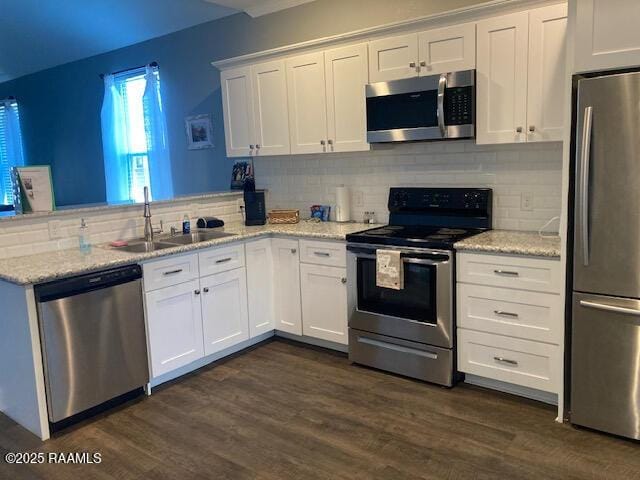 236 Chatrian St, Grand Coteau, LA 70541 - kitchen featuring appliances with stainless steel finishes, a peninsula, white cabinetry, and backsplash