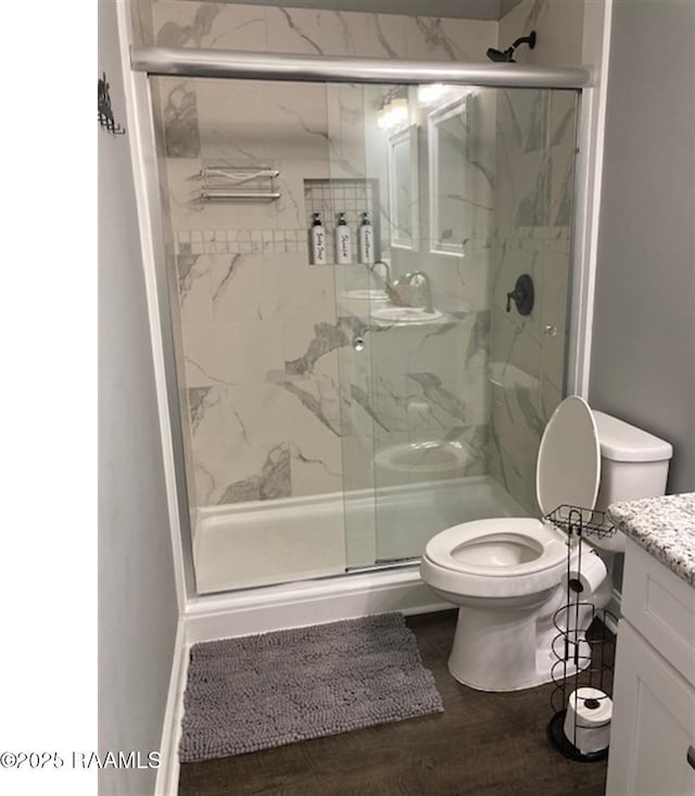 236 Chatrian St, Grand Coteau, LA 70541 - bathroom with toilet, vanity, a marble finish shower, and wood finished floors