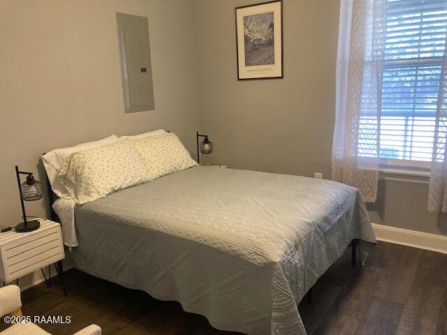 236 Chatrian St, Grand Coteau, LA 70541 - bedroom with electric panel, wood finished floors, and baseboards