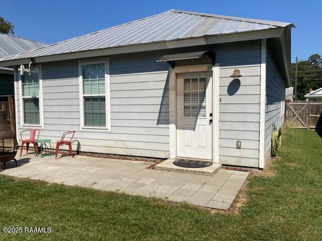 236 Chatrian St, Grand Coteau, LA 70541 - rear view of property featuring metal roof and a patio area