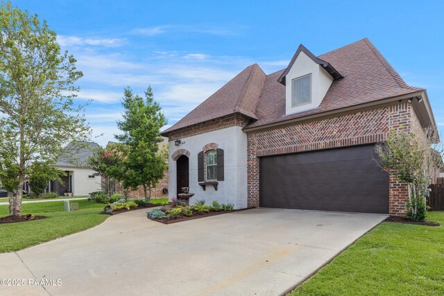 108 Autumnbrook Dr, Broussard, LA 70518 - french country style house with brick siding, concrete driveway, a front yard, and stucco siding