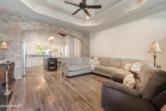 108 Autumnbrook Dr, Broussard, LA 70518 - living area featuring a raised ceiling, ceiling fan, wood finished floors, arched walkways, and crown molding