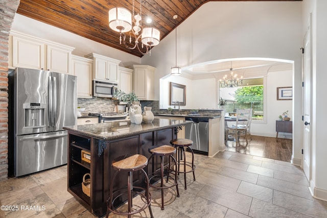 108 Autumnbrook Dr, Broussard, LA 70518 - kitchen featuring appliances with stainless steel finishes, a chandelier, wood ceiling, arched walkways, and a kitchen island