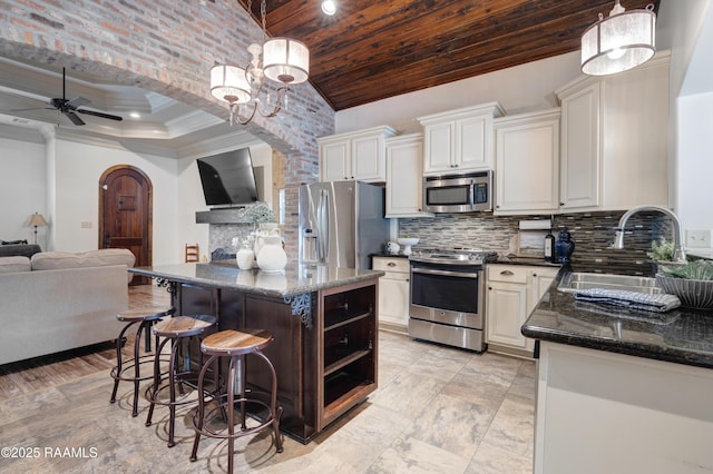 108 Autumnbrook Dr, Broussard, LA 70518 - kitchen featuring appliances with stainless steel finishes, a sink, open floor plan, arched walkways, and a ceiling fan