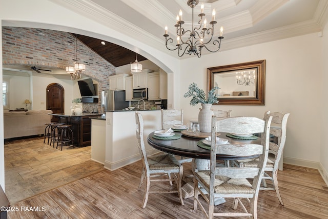 108 Autumnbrook Dr, Broussard, LA 70518 - dining space featuring arched walkways, vaulted ceiling, a chandelier, ceiling fan, and crown molding
