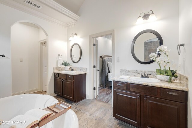 108 Autumnbrook Dr, Broussard, LA 70518 - full bathroom featuring two vanities, vaulted ceiling, a tub to relax in, crown molding, and baseboards