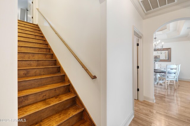 108 Autumnbrook Dr, Broussard, LA 70518 - staircase featuring crown molding, a chandelier, wood finished floors, arched walkways, and baseboards
