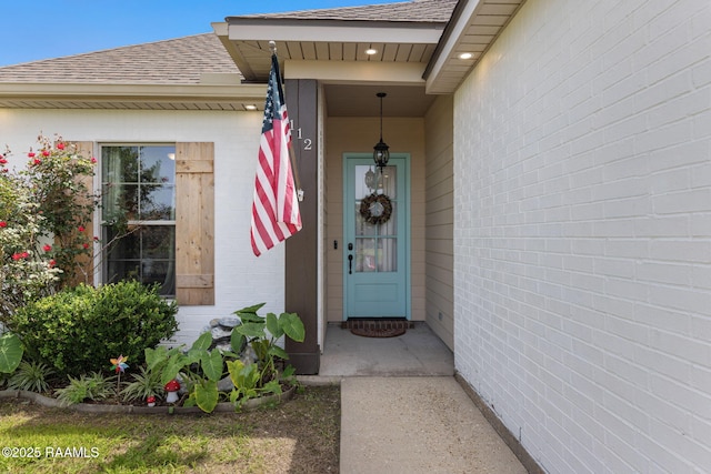 112 Sandhill Crane Dr, Lafayette, LA 70508 - view of exterior entry featuring roof with shingles and brick siding