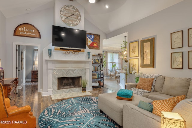112 Sandhill Crane Dr, Lafayette, LA 70508 - living room featuring high vaulted ceiling, baseboards, wood finished floors, a tiled fireplace, and a chandelier
