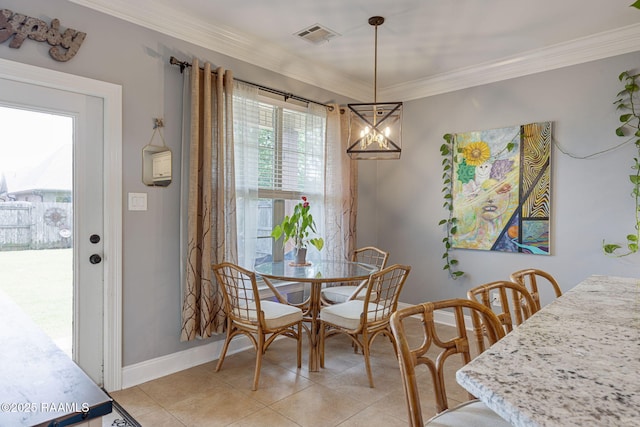 112 Sandhill Crane Dr, Lafayette, LA 70508 - dining area with light tile patterned floors, crown molding, a chandelier, and baseboards