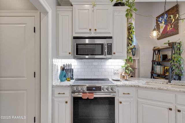 112 Sandhill Crane Dr, Lafayette, LA 70508 - kitchen with stainless steel appliances, a sink, white cabinets, and backsplash