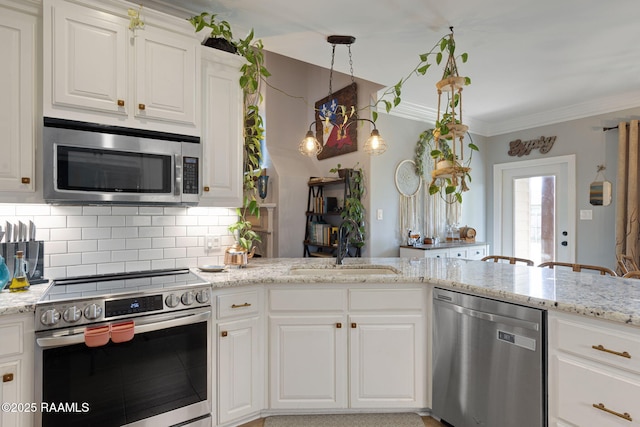 112 Sandhill Crane Dr, Lafayette, LA 70508 - kitchen with stainless steel appliances, a sink, decorative backsplash, white cabinetry, and light stone countertops