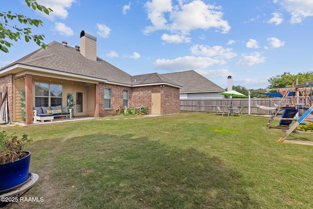 112 Sandhill Crane Dr, Lafayette, LA 70508 - back of property with an outdoor living space, brick siding, roof with shingles, a chimney, and a patio area