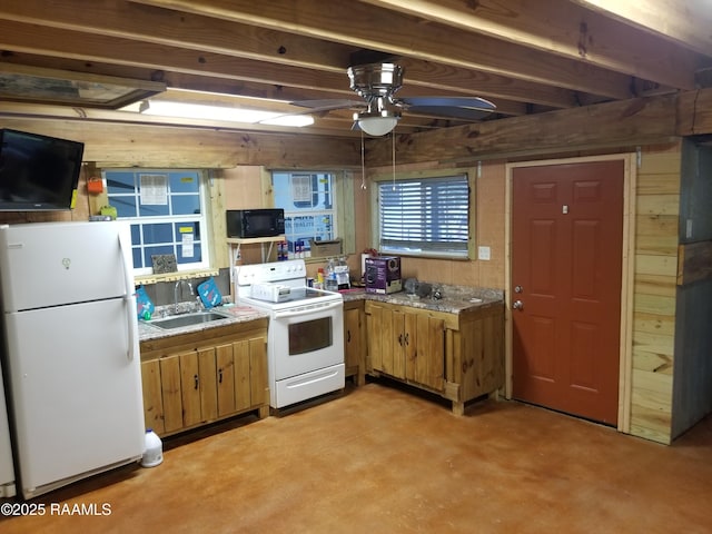 1462 Herman Dupuis Rd, Breaux Bridge, LA 70517 - kitchen with white appliances, wood walls, ceiling fan, a sink, and brown cabinets