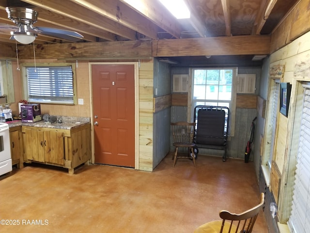 1462 Herman Dupuis Rd, Breaux Bridge, LA 70517 - kitchen featuring wood walls, concrete floors, ceiling fan, light countertops, and white electric range