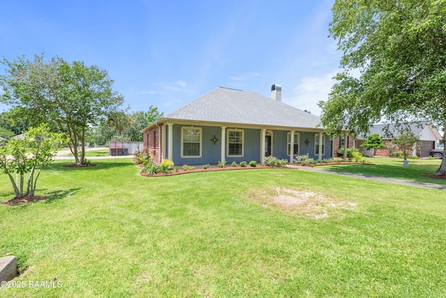201 Rue Paon, Youngsville, LA 70592 - view of front of house with a front lawn and a chimney