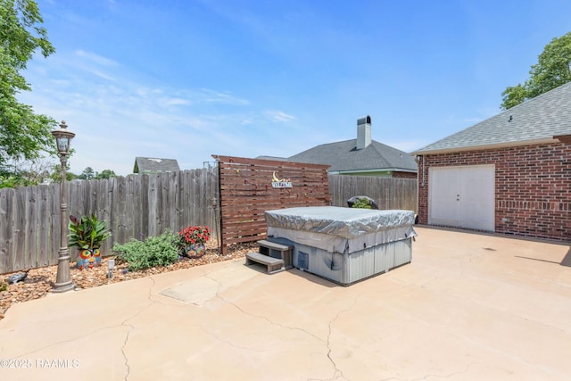 201 Rue Paon, Youngsville, LA 70592 - view of patio / terrace featuring a hot tub and fence