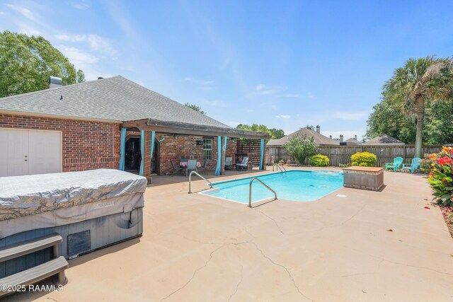 201 Rue Paon, Youngsville, LA 70592 - view of pool with a hot tub, a patio area, and a fenced backyard