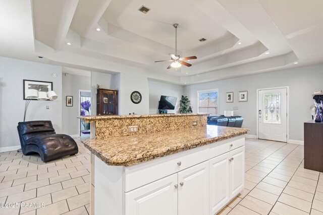 201 Rue Paon, Youngsville, LA 70592 - kitchen with open floor plan, a tray ceiling, light tile patterned floors, ceiling fan, and recessed lighting