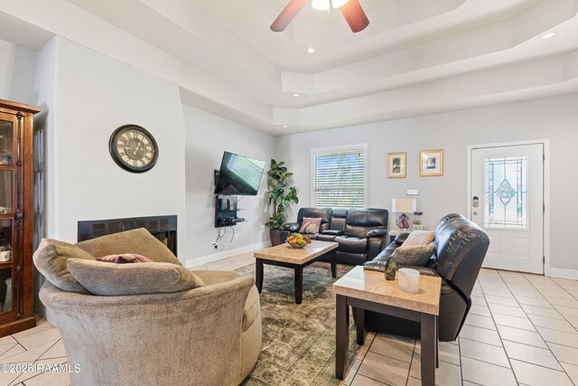 201 Rue Paon, Youngsville, LA 70592 - living room with light tile patterned flooring, ceiling fan, recessed lighting, a tray ceiling, and baseboards