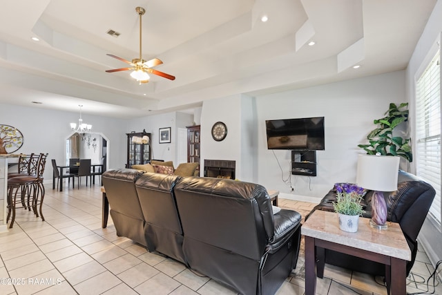 201 Rue Paon, Youngsville, LA 70592 - living room with a tray ceiling, a ceiling fan, light tile patterned floors, a chandelier, and recessed lighting