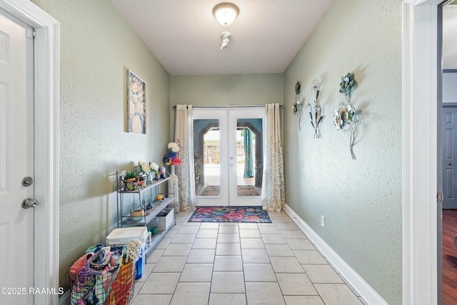 201 Rue Paon, Youngsville, LA 70592 - entryway with french doors, a textured wall, light tile patterned flooring, and baseboards