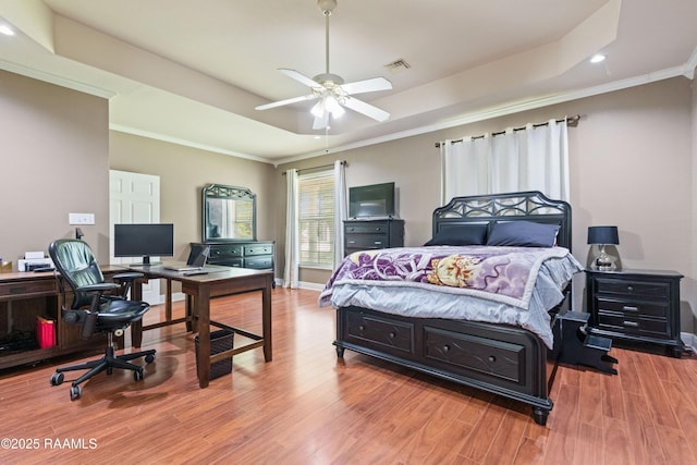 201 Rue Paon, Youngsville, LA 70592 - bedroom with a tray ceiling, an office area, wood finished floors, ornamental molding, and recessed lighting