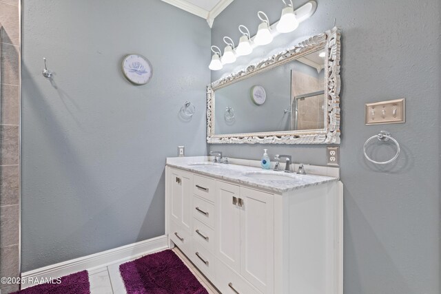 201 Rue Paon, Youngsville, LA 70592 - bathroom with a shower stall, ornamental molding, double vanity, and baseboards