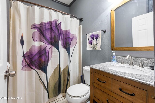 201 Rue Paon, Youngsville, LA 70592 - bathroom featuring vanity, toilet, a textured wall, and curtained shower