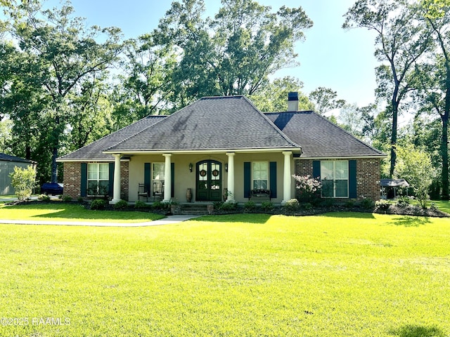 277 Carrera Ln, Eunice, LA 70535 - view of front of house with a porch, a chimney, a front lawn, roof with shingles, and brick siding