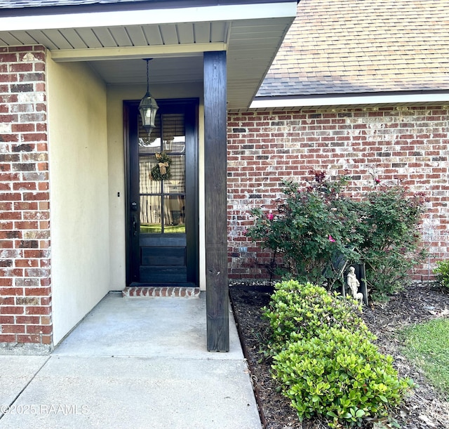 277 Carrera Ln, Eunice, LA 70535 - entrance to property featuring brick siding and a shingled roof