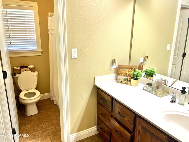 277 Carrera Ln, Eunice, LA 70535 - bathroom featuring vanity, toilet, tile patterned flooring, and baseboards