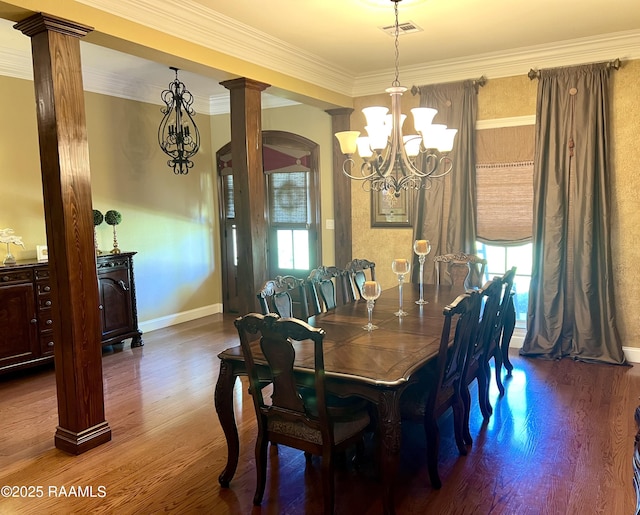 277 Carrera Ln, Eunice, LA 70535 - dining space featuring plenty of natural light, a chandelier, decorative columns, wood finished floors, and ornamental molding