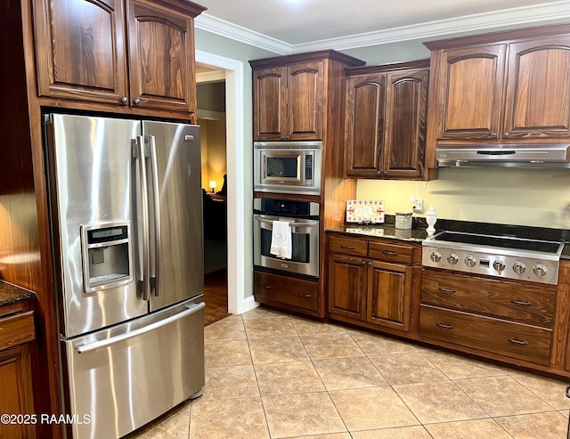 277 Carrera Ln, Eunice, LA 70535 - kitchen with stainless steel appliances, under cabinet range hood, ornamental molding, dark stone countertops, and light tile patterned floors