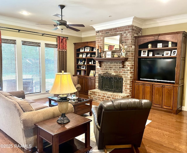 277 Carrera Ln, Eunice, LA 70535 - living area with ceiling fan, crown molding, light wood-style flooring, and a brick fireplace